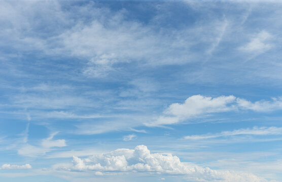 Sunny blue sky with clouds on partly cloudy day for background backdrop texture or sky replacement layer for composite art