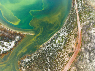 Aerial view of a track leading through colourful salt lakes in the Pithara area of the Wheatbelt region of Western Australia