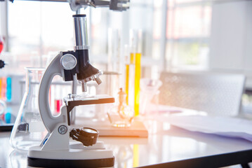 Science microscope equipment in biology chemical laboratory. Scientific experiment Microscope on Lab table microbiology equipment. Chemistry objects on lab background. Chemistry scientific concept