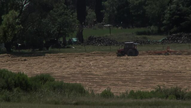 Farmer in Tractor Plowing Field in Entre Rios Province, Argentina, South America. 