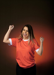 woman soccer fan cheering for her favorite club and team. world cup orange background