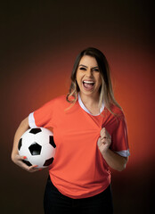 woman soccer fan cheering for her favorite club and team. world cup orange background