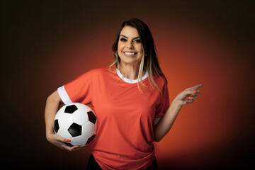 woman soccer fan cheering for her favorite club and team. world cup orange background