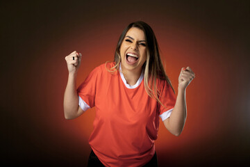 woman soccer fan cheering for her favorite club and team. world cup orange background