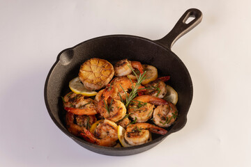 Spicy garlic chilli Prawns Shrimps on frying pan with lemon and cilantro
