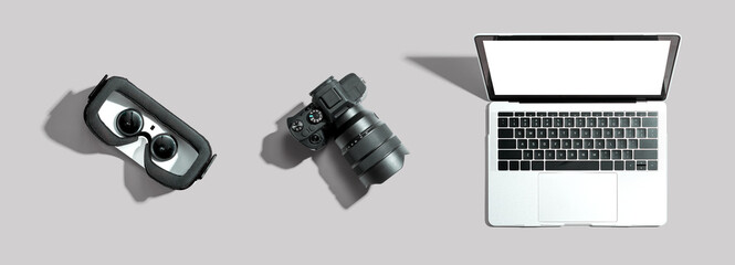 Tech gear theme with vr headset, dslr camera and laptop