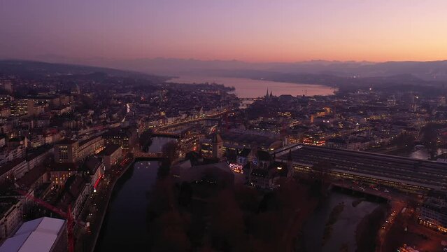 Zurich, Switzerland: Aerial drone footage of the sunset over Zurich city center with the Limmat river that flows through the old town to join lake Zurich in Switzerland. Shot as a time lapse
