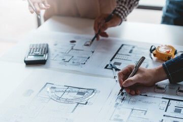 Architect or engineers are meeting to discuss home design. modify plans build a construction project and modify the work according to the needs of the customer.