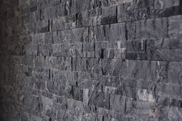 Soft focus dark gray stone pattern wall. black slate wall background