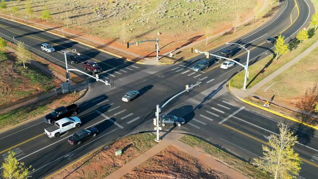 4K Drone footage of busy car intersection in rural Wyoming during sunset after work
