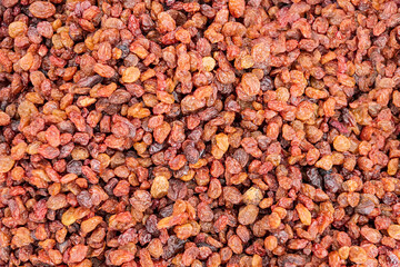 Texture surface from pile of dry grapes (raisins). Trade counter with goods ready for sale.