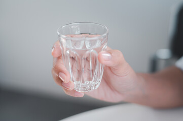 hand with glass of water