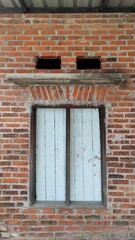 Vintage background of the window from old vintage unfinished house in urban area