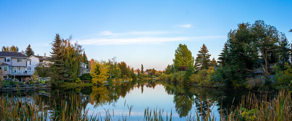 view down the lake with houses on the side perfect reflections