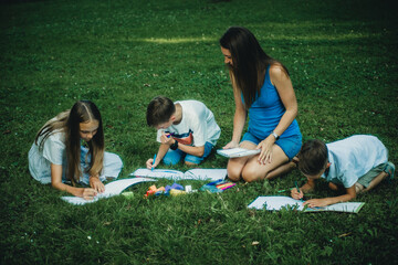 woman playing with children in nature