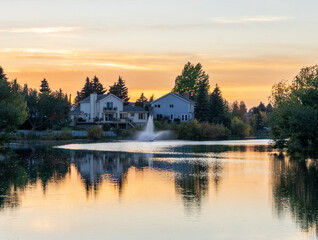 sunset over the lake with a fountain and vivid reflections