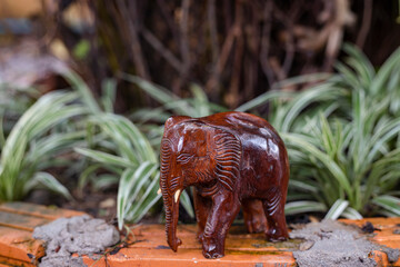 Statuette of wooden elephant  on blur background. Quality photo for art work and advertised. image of hand made.