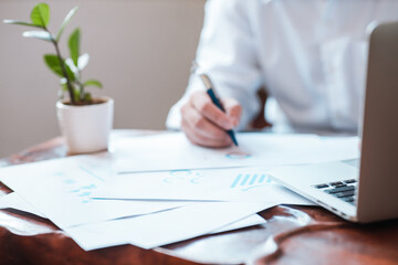 Hand businessman signing contract. Asia businessman check the correctness of work at the office with a beautiful pen. Hands working with documents at desk and signing contract.Deal concept.