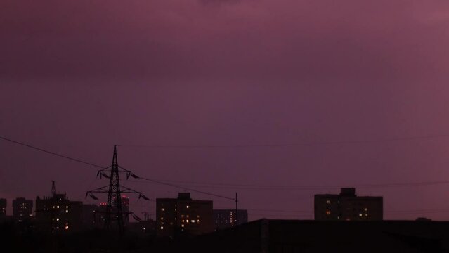 Thunderstorm and lightning flashes over the city at night