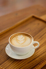 hot coffee latte Placed on a chopping board at a coffee shop in Chiang Mai, Thailand, on 29.92.2022.