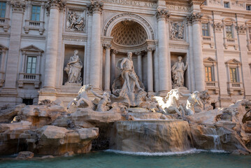Fototapeta na wymiar The Trevi's Funtain, in the Center of Rome, At Sunset with Parts of it Illuminated By the Sun
