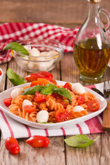 Fusilli pasta with cherry tomatoes and mozzarella cheese.