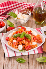Fusilli pasta with cherry tomatoes and mozzarella cheese.