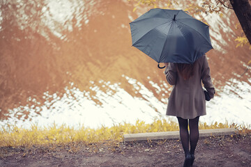 Young girl in a coat in autumn  park