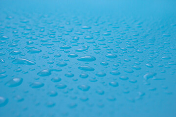 Close up of dropped water on a blue background. Freshness, raindrop