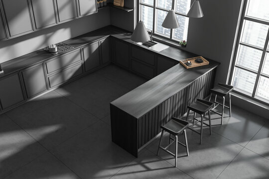 Top view of grey kitchen interior with countertop and kitchenware, window
