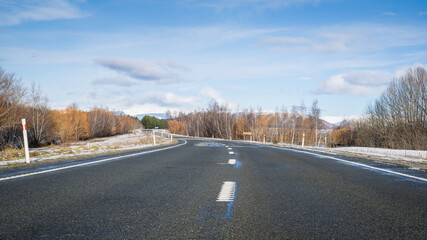 Winter road in Twizel, snow on the sides of the road, South Island.