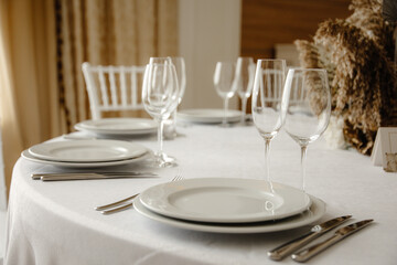 Served dinner table in a restaurant. Restaurant interior, table setting for a dinner, table set for a dinner.