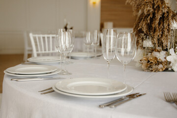 Served dinner table in a restaurant. Restaurant interior, table setting for a dinner, table set for a dinner.