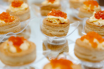 Delicious snacks with caviar served in puff pastry towers