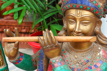 Krsna is the supreme personality of God. Krishna is playing the flute. Indian sculpture.