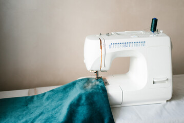 Sewing machine and fabric. Concept: atelier, sewing business, sewing courses, needlework workshop, sewing hobby, tailoring to order.