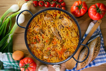 Paella with noodles, rabbit and vegetables. Tapa typical of the Spanish coast.
