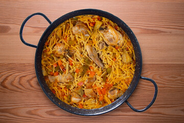 Paella with noodles, rabbit and vegetables. Tapa typical of the Spanish coast.