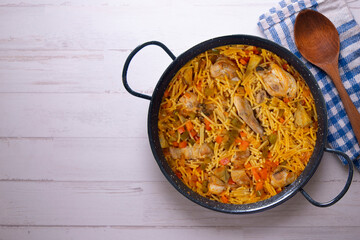Paella with noodles, rabbit and vegetables. Tapa typical of the Spanish coast.