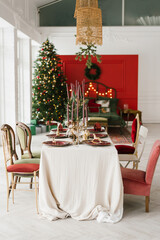 Elegant festive table set for Christmas dinner in the interior of a classic living room