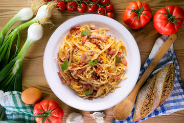 Spaghetti a la cardinale. Pasta cooked with cream and bacon. Traditional Italian recipe.