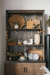 Wooden cabinet and kitchen utensils, dishes and Christmas decor for New Year