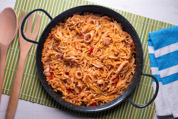 Paella with noodles, squid and seafood. Tapa typical of the Spanish coast.
