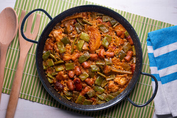 Paella with green beans and sausages. Typical Spanish paella tapa recipe with meat.