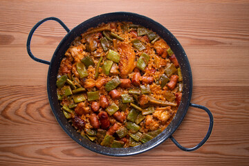 Paella with green beans and sausages. Typical Spanish paella tapa recipe with meat.