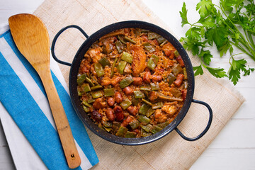 Paella with green beans and sausages. Typical Spanish paella tapa recipe with meat.