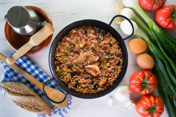 Rabbit and sausage paella. Typical Spanish paella tapa recipe with meat.