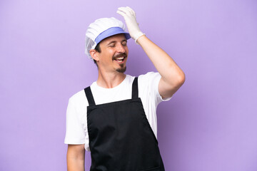 Fishmonger man wearing an apron isolated on purple background has realized something and intending the solution
