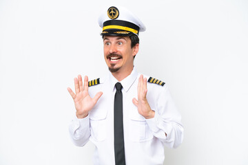 Airplane caucasian pilot isolated on white background with surprise facial expression