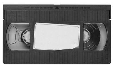 Old vintage vhs video cassette tape with a blank paper label. Magnetic videotape movie storage